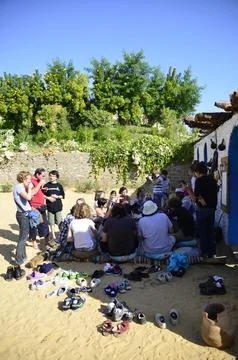 Group sits together in Aswan, Egypt near the Nile Stock Photos