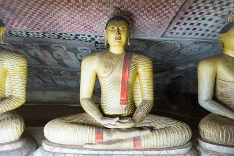 Group of sitting Buddha statues in cave buddhist temple Stock Photos
