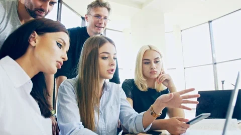 A group of six students are working on a project with a laptop Stock Footage 119825861