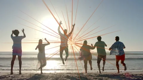 Group of six walking running jumping to sun nearing shore causing orange burst Video stock 333286383