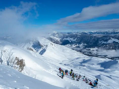 A group of ski tourers having a pause on the summit of Haengst, Switzerland Stock Photos