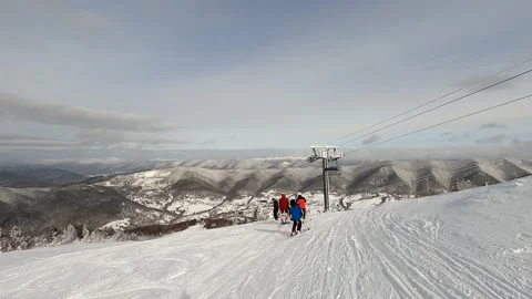 A group of skiers in multi-colored ski suits  Stockbeeldmateriaal 170657465