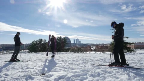 Group of skiers relax while overlooking the financial district skyscrapers in Stock Footage 146330941