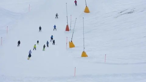 Group of skiers skiing down mountain slope in winter in davos klosters Stock-Footage 328146160