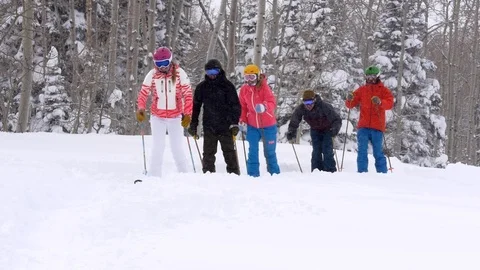 Group of skiers walk on trail while snowing, Park City, Utah. Video stock 99258072