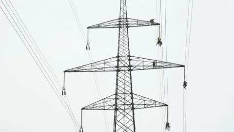Group of skilled workers repairs electrical wiring on electric tower Stock Footage 140803289