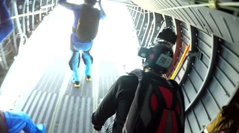 Group of skydivers is jumping out of airplane and hovering in free fall Stock Footage 60840947