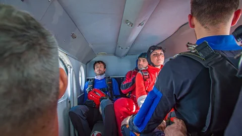 Group Of Skydivers Laughing And Preparing In Cockpit Of Plane Before Jump Stock Footage 128063352
