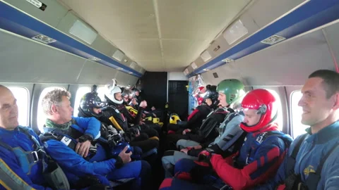 Group of skydivers sits inside a small plane awaiting a jump Stock Footage 96494788