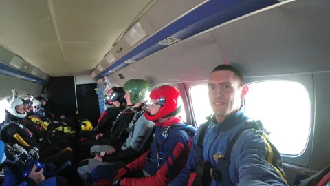 Group of skydivers sits inside a small plane awaiting a jump Stock Footage 96531952