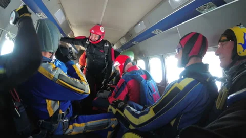 Group of skydivers sits inside a small plane awaiting a jump Stock Footage 96547358