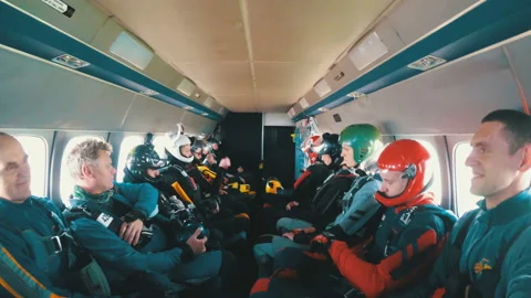 Group of skydivers sits inside a small plane awaiting a jump Stock Footage 96590257