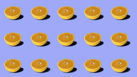 Group of sliced oranges on violet background. Stock Photos