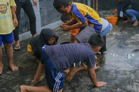 A group of small children having fun winning coins Stock Photos