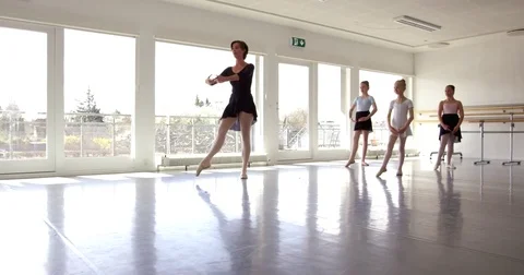 Group of small sporty pretty girls exercising and dancing ballet in the class Stock Footage
