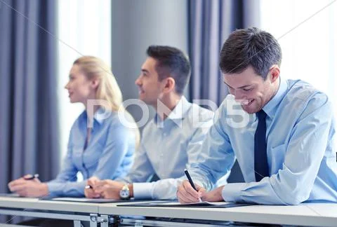 Group of smiling businesspeople meeting in office Stock Photos