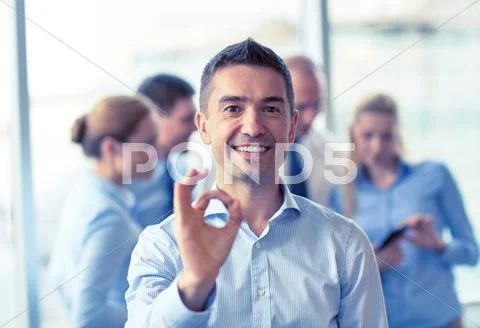 Group of smiling businesspeople meeting in office Stock Photos