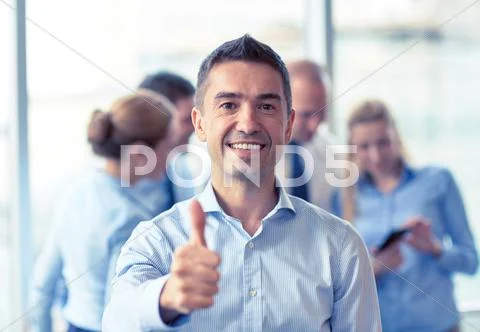 Group of smiling businesspeople meeting in office Stock Photos
