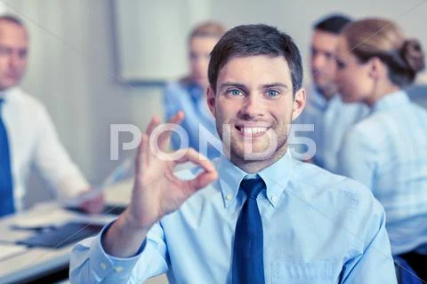 Group of smiling businesspeople meeting in office Stock Photos