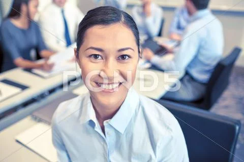 Group of smiling businesspeople meeting in office Stock Photos