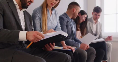 Group of smiling job seekers sitting and preparing for interview, discussing Stock Footage 308064607
