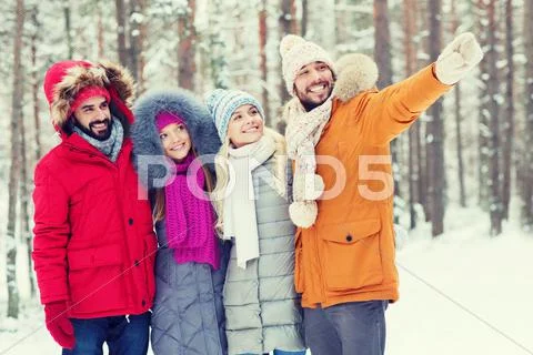 Group Of Smiling Men And Women In Winter Forest
