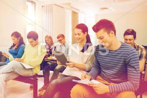 Group of smiling students with tablet pc Stock Photos