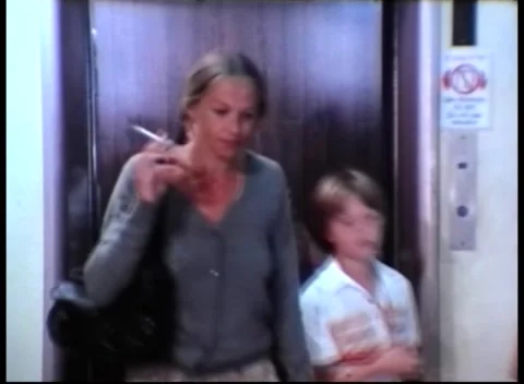 GROUP OF SMOKERS WALK OUT OF AN ELEVATOR (1978) Stock Footage 247385330