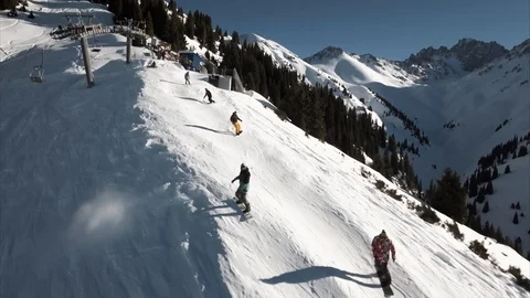 Group of snowboarder going down the snowy mountains, aerial shot Video stock 90028002