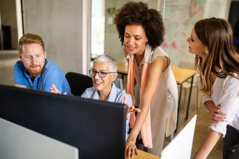 Group of software engineers working developing applications together in Stock Photos