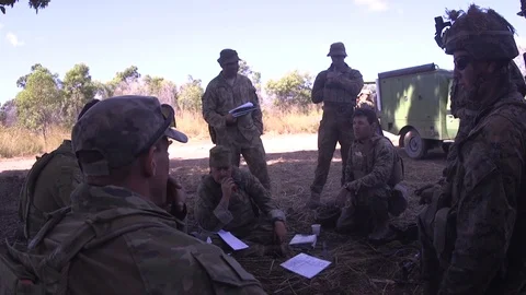 Group of soldiers disusing over the drawing and layouts of area - 2018 Stock Footage 99775753