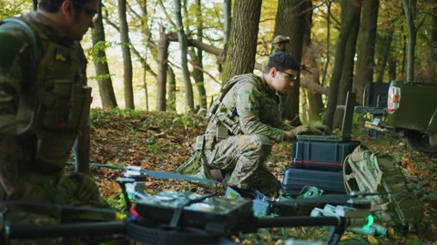 Group of soldiers using laptop computer for surveillance during a military Stock Footage 241009810