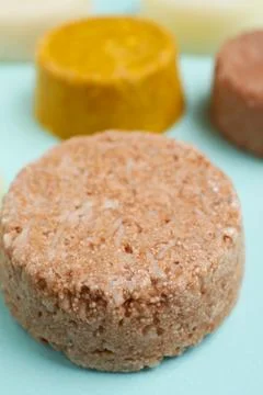 Group of solid shampoo bar on turquoise table, closeup. Hair care 写真素材