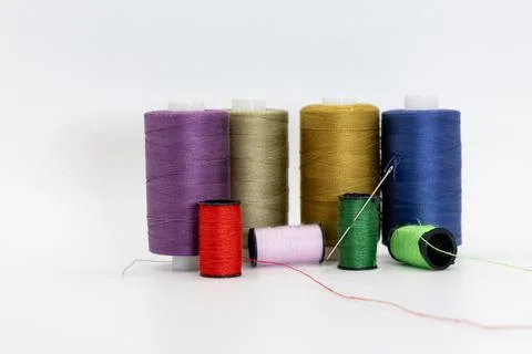 A group of spools and thread in different colors Stock Photos