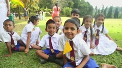 Smiling Young School Children In A School Uniform Jumping On The