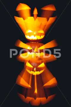 Group of stacked Halloween Jack o Lanterns with black background Stock Photos