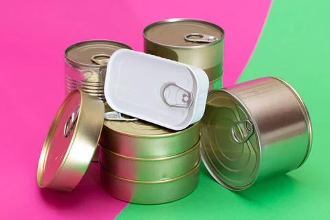 A Group of Stacked Tin Cans on Split Green and Cyan Background Foto stock