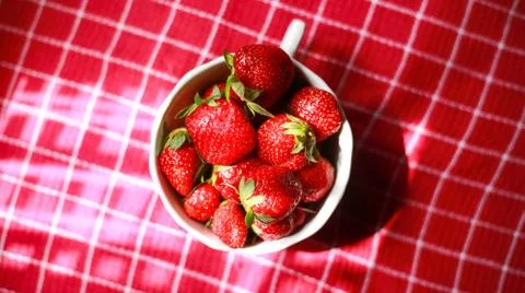 Group of strawberry in a white bowl with red colour background Stock Photos