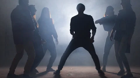 Group of street dancers performing different moves on dark street Stock Footage 108274856