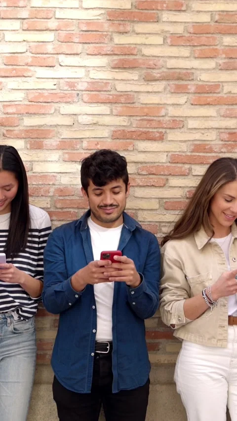 Group of student people using mobile phone over city wall background Stock Footage 278860996