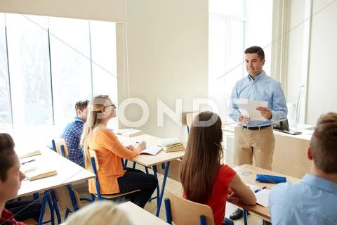 Group of students and teacher with papers or tests Stock Photos