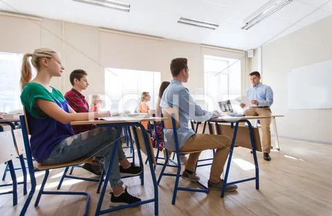 Group of students and teacher with papers or tests Stock Photos