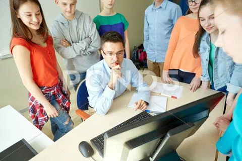 Group of students and teacher at school classroom Stock Photos