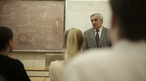 Group of students in a classroom, listening as their teacher holds a lecture. Stock Footage 44234214