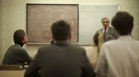 Group of students in a classroom, listening as their teacher holds a lecture. Stock Footage 44234740