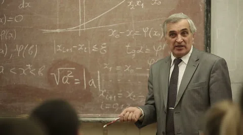 Group of students in a classroom, listening as their teacher holds a lecture. Stock Footage