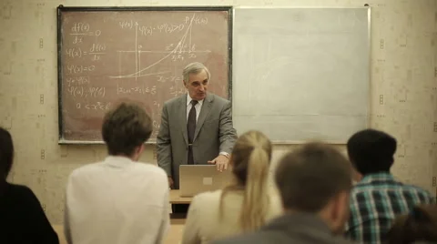Group of students in a classroom, listening as their teacher holds a lecture. Stock Footage 44235631