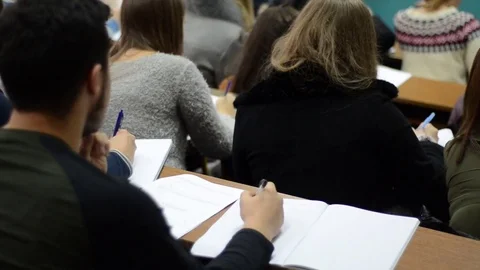 Group of students in a classroom. Students listening in a lecture hall Stock Footage 82505642