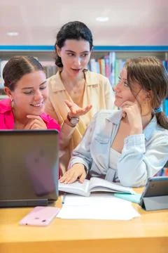 Group of students collaborating on a project in a library.Vertical Stock Photos