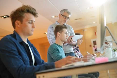 Group of students in computing class with teacher Stock Photos